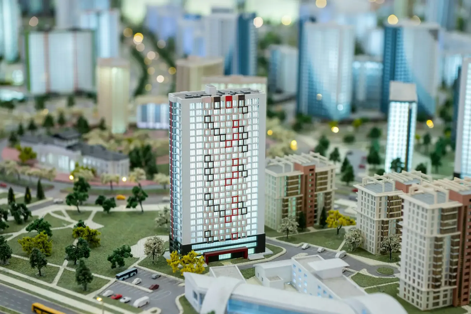 A miniature city on the table. Layout of a block with a residential building.
