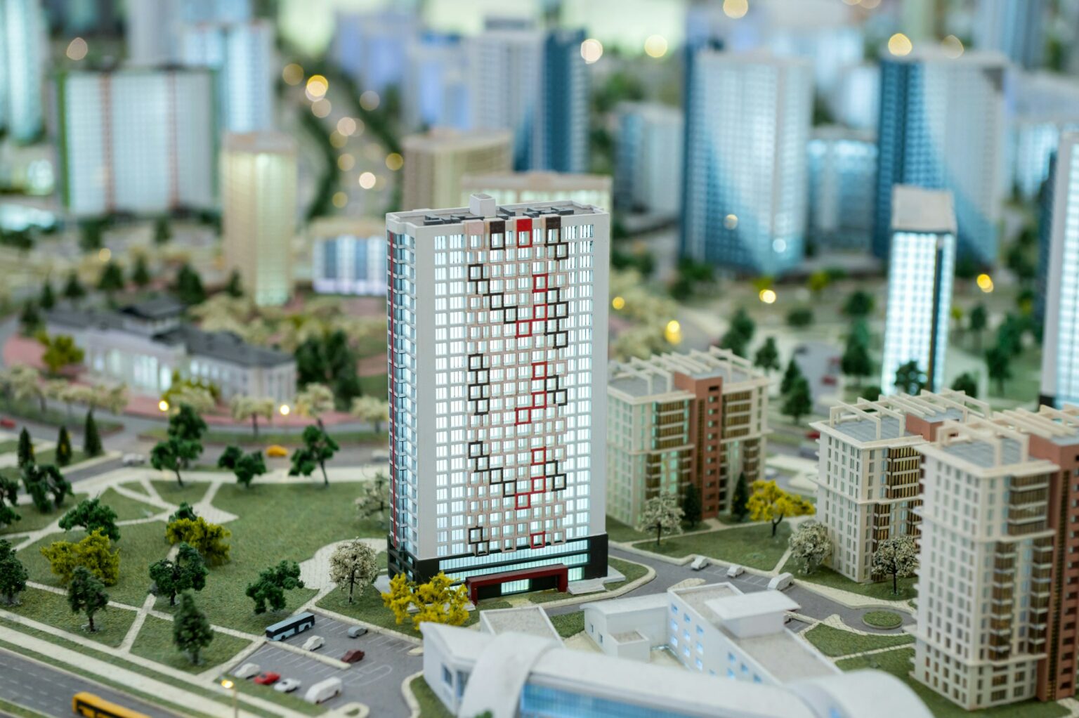 A miniature city on the table. Layout of a block with a residential building.
