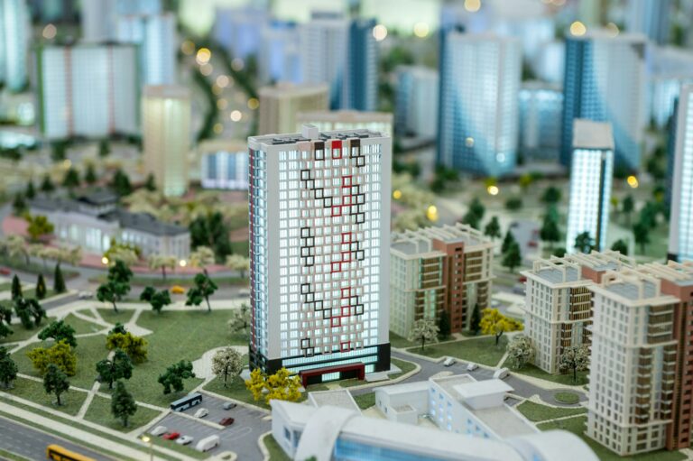 A miniature city on the table. Layout of a block with a residential building.