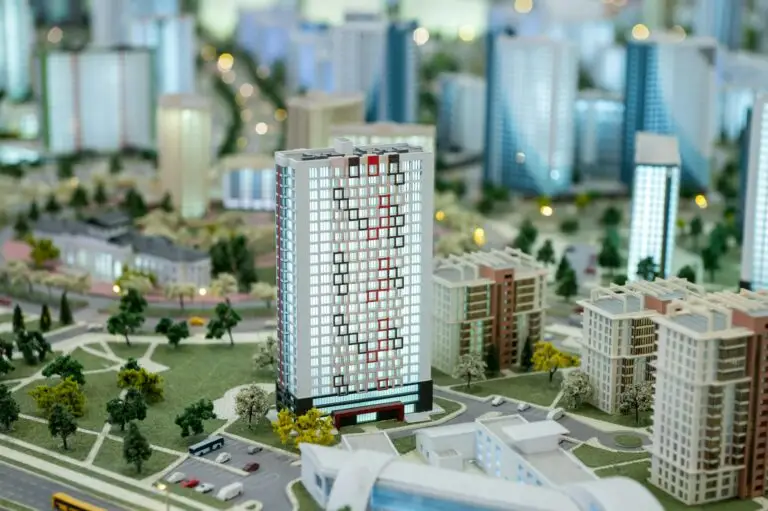 A miniature city on the table. Layout of a block with a residential building.