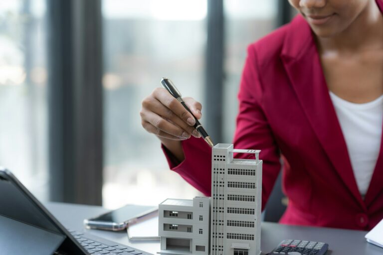 Female real estate agent offering to sell a house or condo Commercial building and house