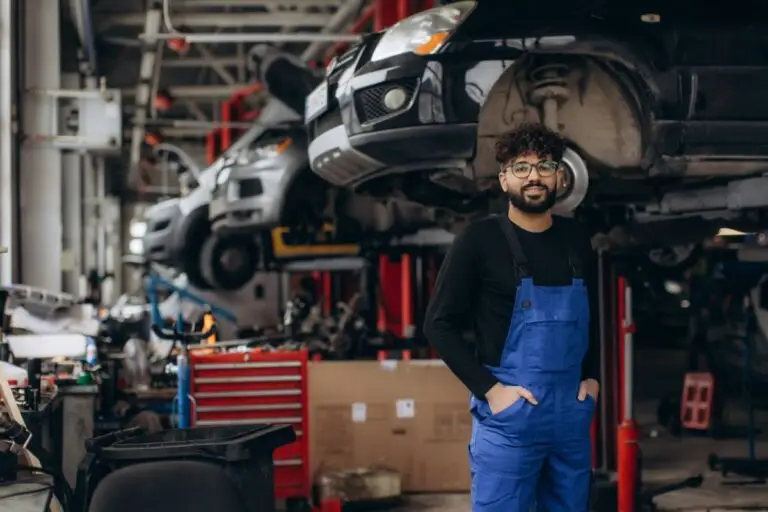 Finance an auto repair shop - shop owner stands in auto shop bay